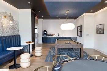 A room with a pool table and a bar.